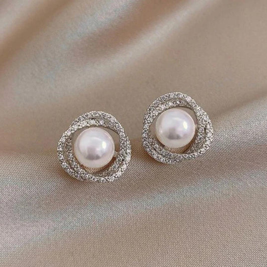 Shimmering spiral earrings with elegant pearls Jula Jewelry