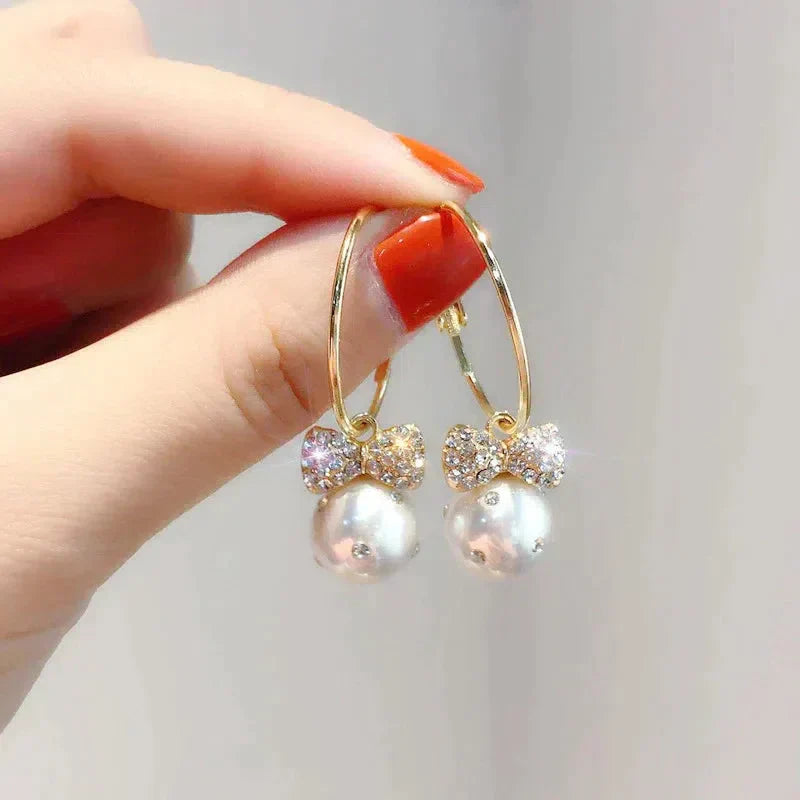Shiny Gold Earrings Adorned with Pearls Jula Jewelry