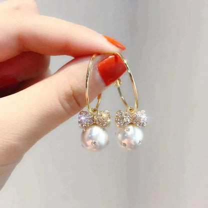 Shiny Gold Earrings Adorned with Pearls Jula Jewelry