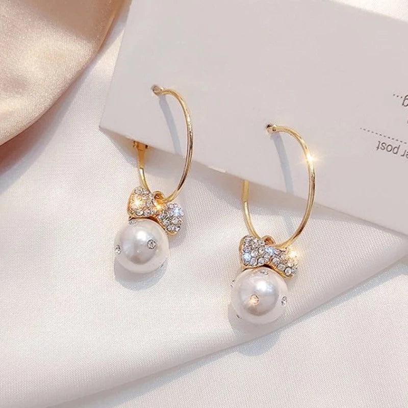 Shiny Gold Earrings Adorned with Pearls Jula Jewelry