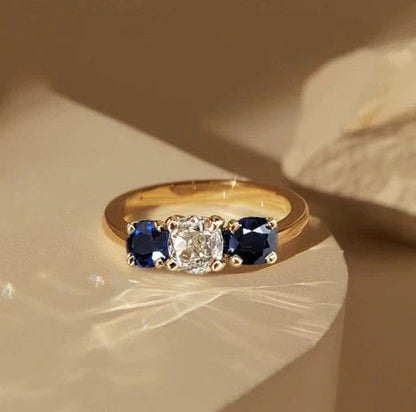 1+1 Offer: Golden Three Stone Cushion Cut White & Blue Sapphire Wedding Band Ring for Women + Round Cut White Sapphire Gold Necklace Jula Jewelry