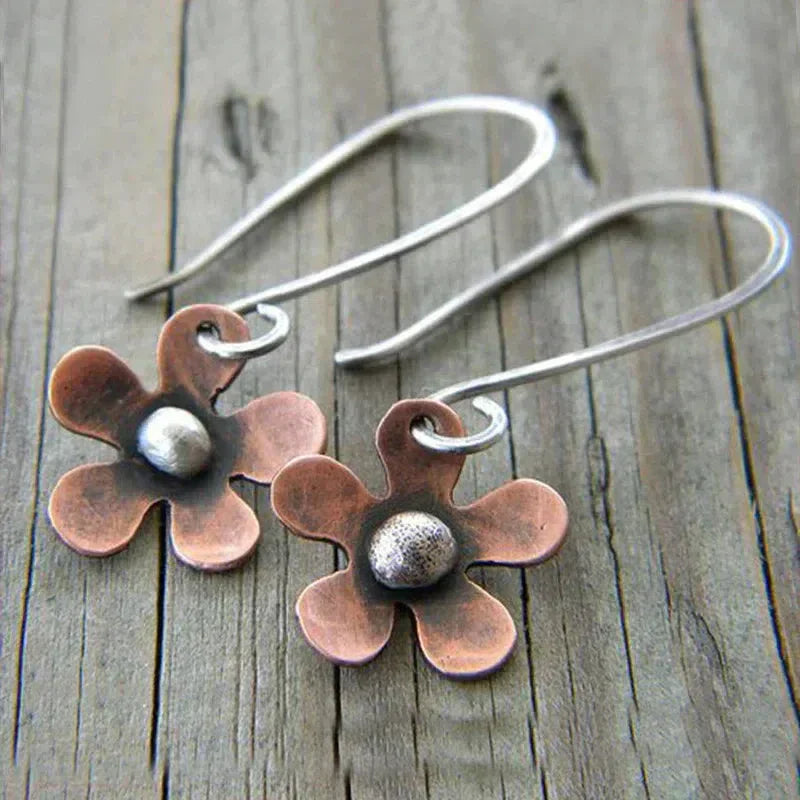 Boho earrings featuring a brown flower crafted from sterling silver. Jula Jewelry