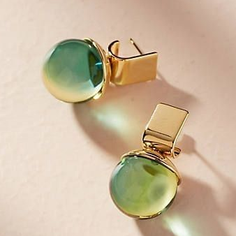 Vintage earrings featuring green crystals set in gold. Jula Jewelry