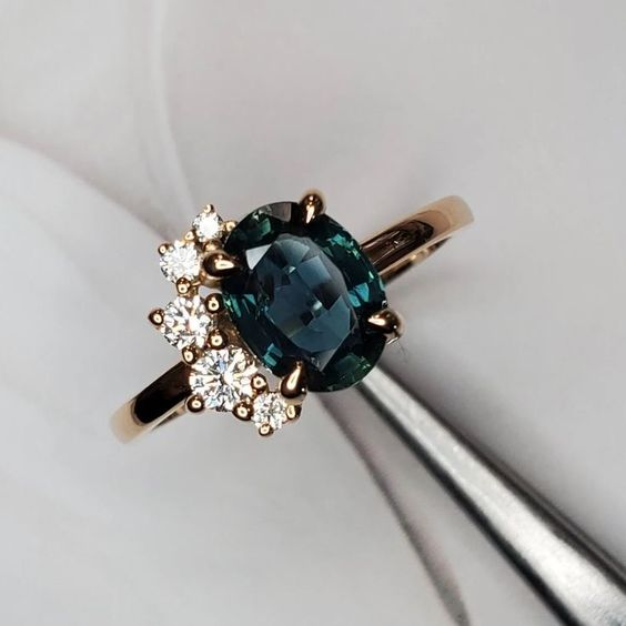 Vintage ring featuring a blue crystal and zirconia. Jula Jewelry